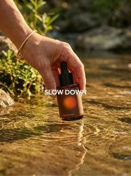 Slow down — Water — the bottle held in a stream